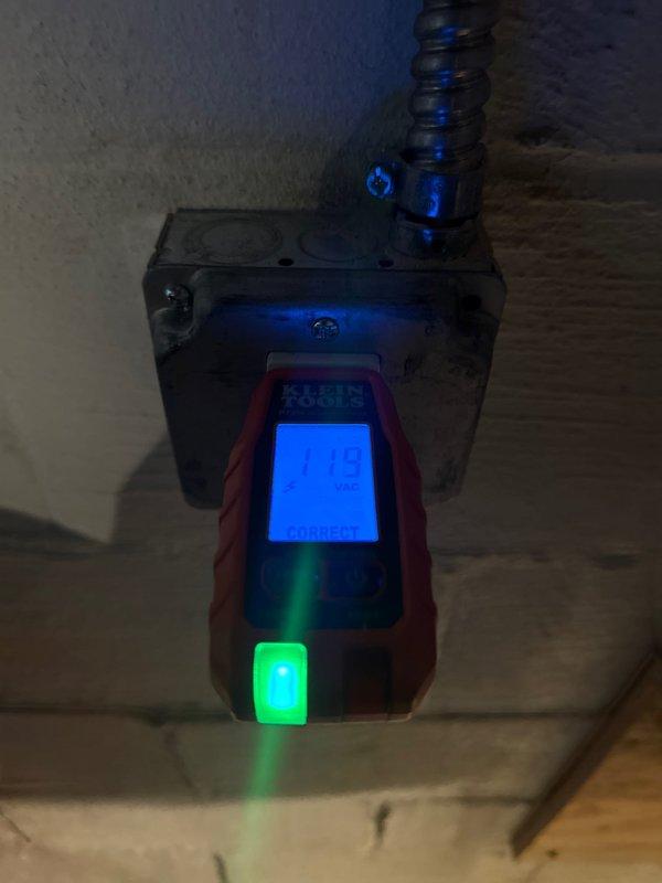 Completed installation of dedicated circuit for tankless PWI. Tested the outlet with digital voltage meter confirming 128 VAC with correct wiring configuration. Verified proper grounding and connection integrity of the new circuit.