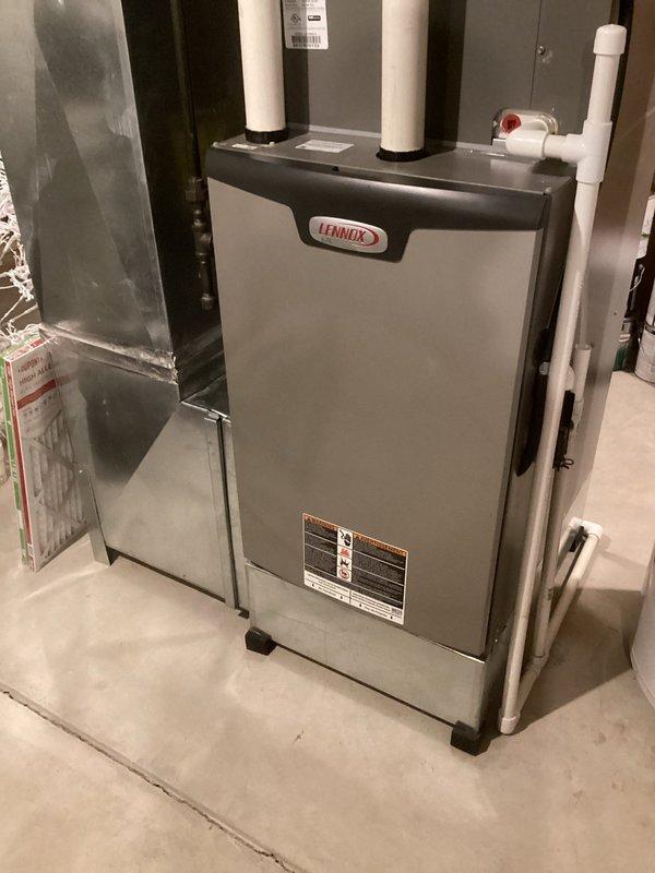 Performed scheduled MVP heating maintenance service on Lennox furnace unit. Inspected blower motor assembly and electrical connections, noting some rust/corrosion on the metal base platform beneath the motor. System is currently operating within normal parameters with no immediate service concerns identified.