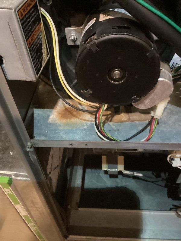 Performed scheduled MVP heating maintenance service on Lennox furnace unit. Inspected blower motor assembly and electrical connections, noting some rust/corrosion on the metal base platform beneath the motor. System is currently operating within normal parameters with no immediate service concerns identified.