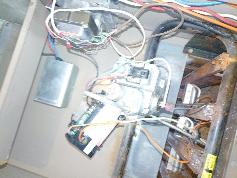 Responded to service call for thermostat showing error codes and intermittent operation. Inspected furnace control board and wiring connections, noting signs of age and discoloration on components. Diagnosed faulty thermostat communication causing irregular heating cycles; repaired electrical connections and restored proper system functionality.