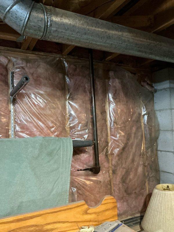 Conducted site assessment for generator installation in unfinished basement with existing gas supply. Evaluated utility area containing galvanized ductwork, insulated walls with vapor barrier, and multiple conduit runs. Created detailed layout diagram noting front/back orientation and elevation requirements for proper generator placement.