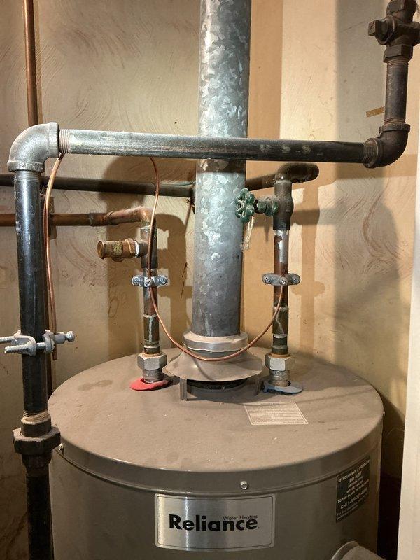 Responded to no hot water complaint on Reliance water heater. Conducted diagnostic assessment of the tank-style water heater and associated components including vent pipe, pressure relief valve, and plumbing connections. Restored hot water service by replacing faulty thermocouple and resetting pilot light.