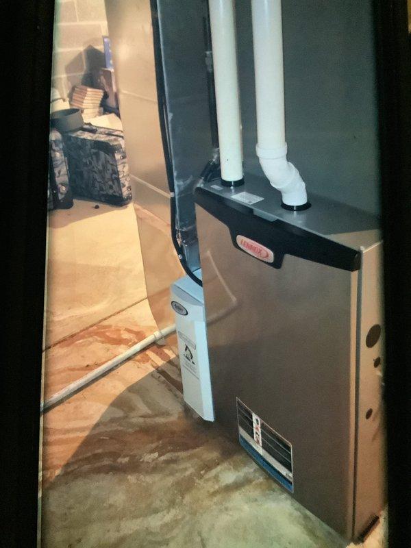 Performed routine maintenance on a 3-year-old heating system. Conducted electrical diagnostics with multimeter showing 15.06 reading on control board components. Inspected furnace unit and ventilation system including PVC exhaust pipes, confirming proper installation and operation.