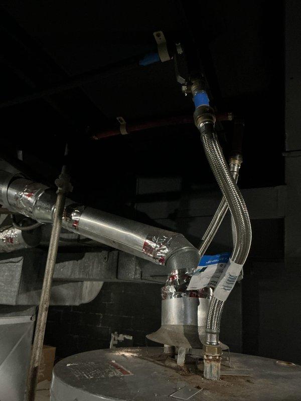 Responded to service call for non-functioning tanked water heater in 80-year-old home. Inspected unit, which showed proper connection of stainless steel flexible connectors and adequately sealed pipe joints. Identified and resolved operational issues, ensuring proper ventilation through the existing metal ductwork, and restored hot water functionality to the system.