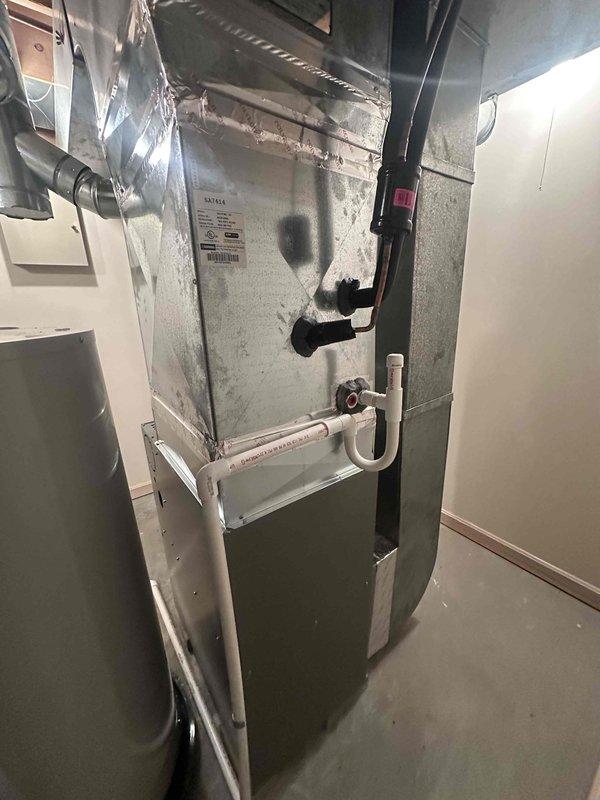 Completed installation of an 80% efficient Lennox furnace along with hot water tank as part of second job phase. Installation included proper ductwork connections sealed with metal tape, PVC condensate drain line routing, and all necessary gas/electrical hookups in utility area. System was mounted securely against wall with all components properly connected and tested.