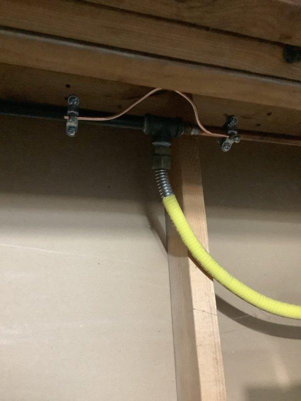 Completed warranty service for failed 200 amp overhead electrical inspection. Installed proper #4 jumpers across water meter and water softener (replacing undersized #6 jumpers), added required retaining clip for sub-panel backfed breaker, and properly bonded yellow CSST gas line per NEC 250.104B and fuel gas code requirements.