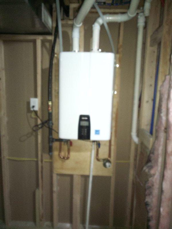 Successfully installed a Navien Npe 240 A2 tankless water heater to replace the customer's 2014 Rheem power vent unit. Installation included mounting the unit on a panel board, utilizing existing ABS pipe for fresh air intake while installing new PVC vent for exhaust, running condensate drain to the floor drain, and installing a new tee and valve for the humidifier. Coordinated with electrician for necessary circuit installation to power the new tankless system.
