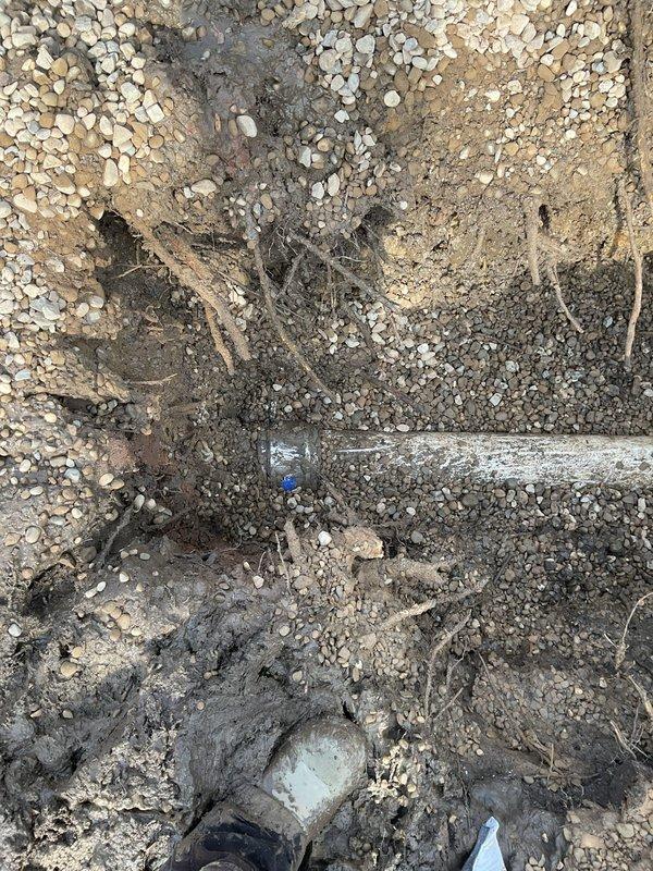 Completed a spot repair of underground plumbing line requiring excavation after tree removal. Exposed and replaced damaged section of galvanized steel pipe, connecting to existing PVC drainage system with appropriate fittings. Installed new vertical PVC riser with protective cap, backfilled with #57 gravel for proper drainage, and restored excavation site.