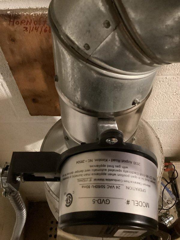 Diagnosed buzzing noise in 56-year-old gas boiler system following automatic damper replacement. Identified Model GVD-5 damper controller as source of noise occurring during heat cycle termination. Recommended full system replacement by 2026 due to age and potential for cascading component failures.