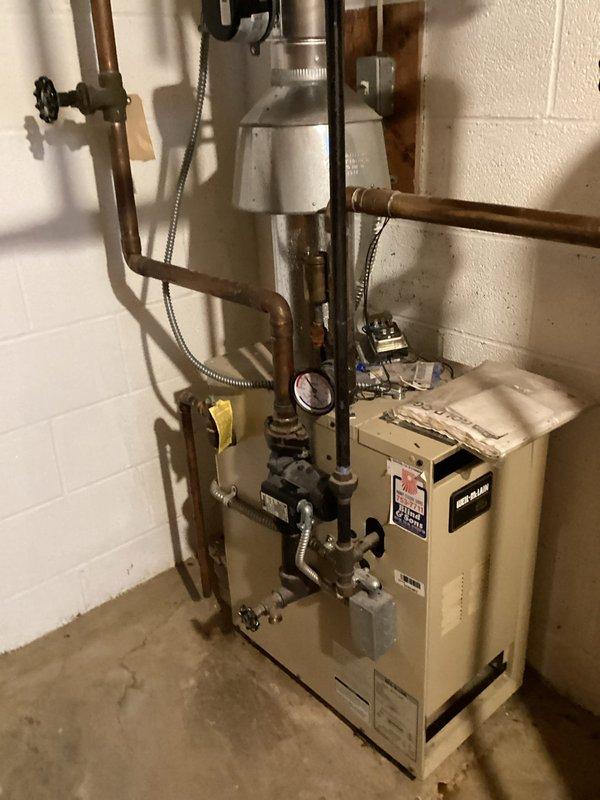 Diagnosed buzzing noise in 56-year-old gas boiler system following automatic damper replacement. Identified Model GVD-5 damper controller as source of noise occurring during heat cycle termination. Recommended full system replacement by 2026 due to age and potential for cascading component failures.