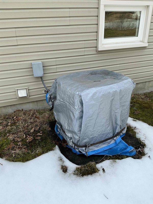 Conducted inspection of 27-year-old Carrier HVAC system for potential replacement. Unit is showing significant age with weatherproofing concerns evident by protective covering on outdoor component. Evaluated existing ductwork configuration and utility room layout to determine appropriate replacement options for both furnace and possible AC upgrade.