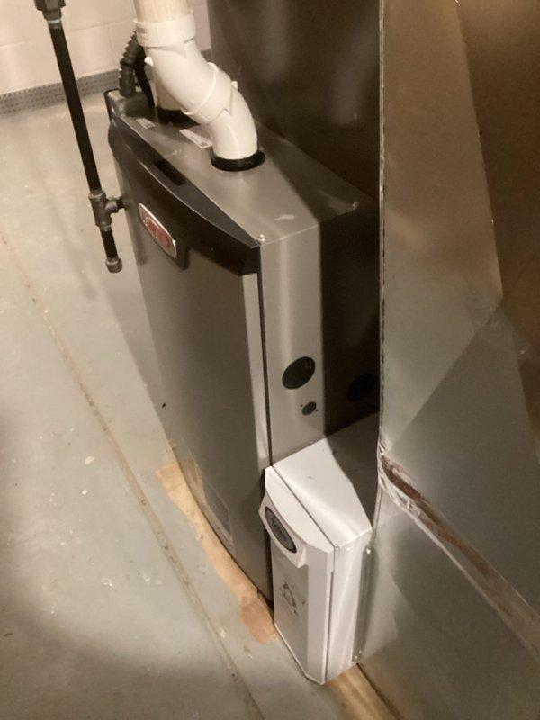 Performed scheduled heating maintenance service on a water heater system. Inspected and verified condition of the unit, including PVC venting and connections. Examined and confirmed proper installation of the air filter in the HVAC system, noting clean pleated filter material with intact frame and strapping.