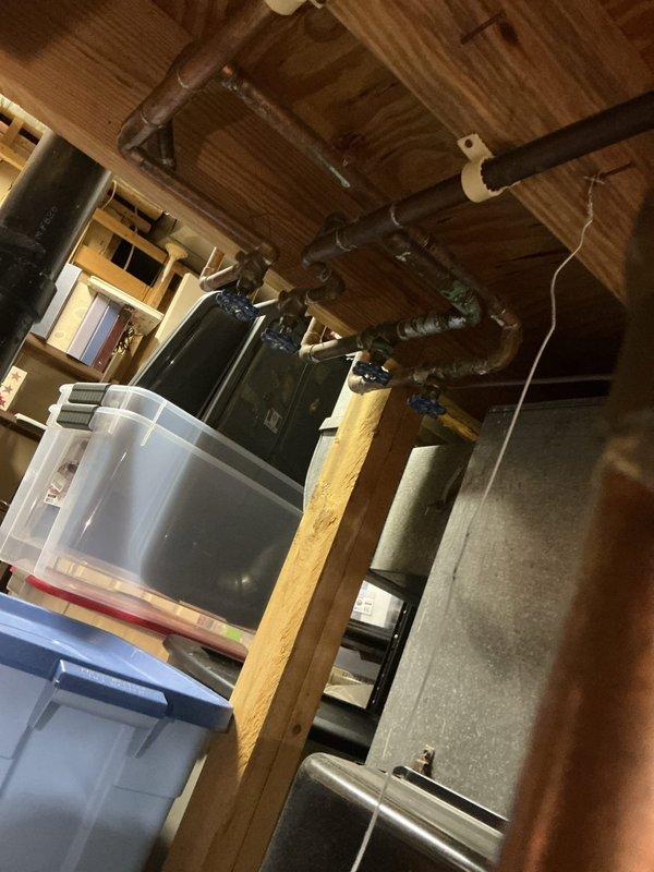 Responded to urgent service call for burst pipes in basement utility area. Inspected exposed plumbing system with significant water damage affecting wooden joists. Assessed damaged hot water tank (PowerStar DELUXE model) and provided separate quotes for pipe repair and complete hot water tank replacement.