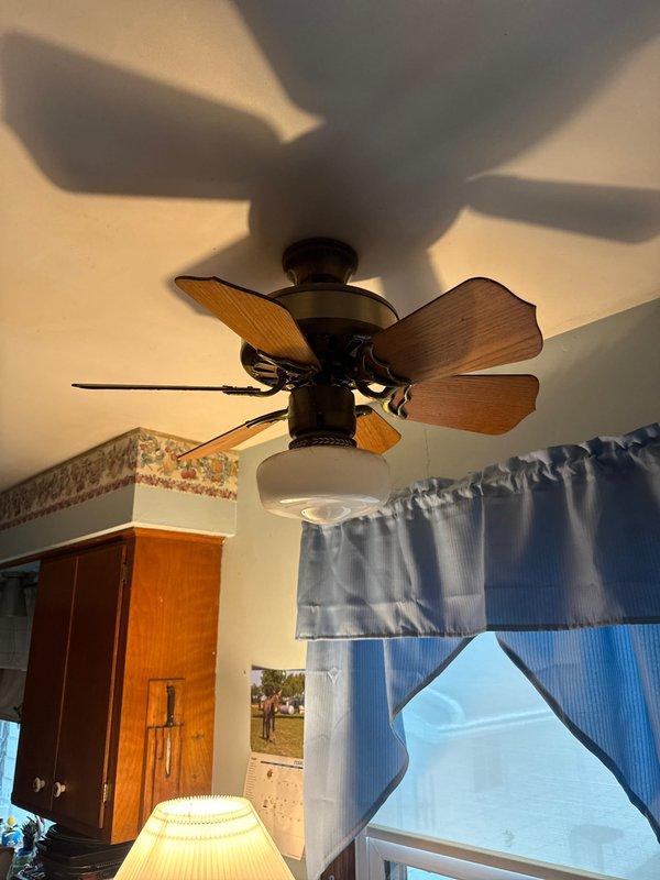 Conducted scheduled inspection of residential electrical fixtures, focusing on porch area lighting with wall-mounted fixture and adjacent outlet with conduit, as well as interior ceiling fan with integrated lighting. Documented existing installation with photos for compliance verification.