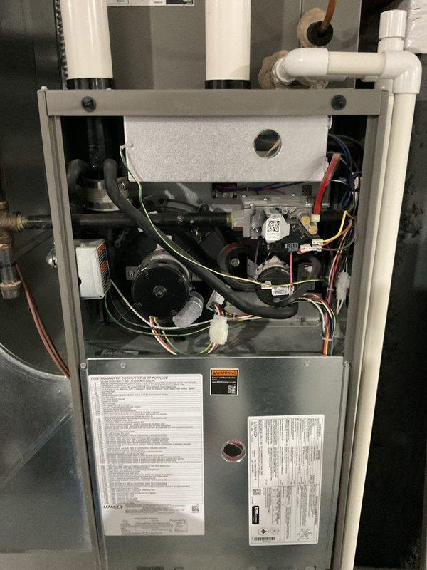 Performed routine maintenance tune-up on 3-year-old furnace. Removed front panel to inspect internal components including blower motor, wiring connections, and ventilation system. All components found in normal working condition with no visible damage or abnormal buildup.