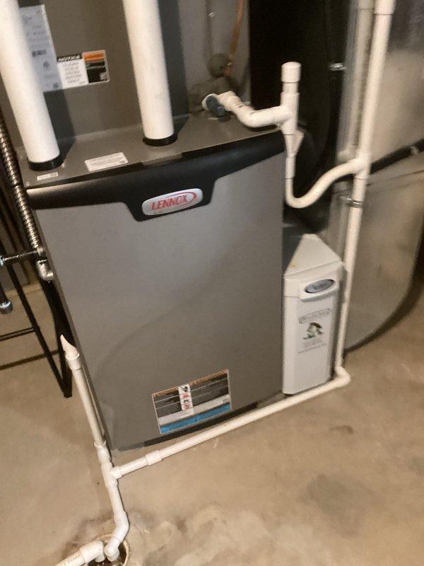 Performed scheduled MVP heating maintenance service on Lennox furnace system. Inspected and documented condition of heat exchanger and air filter components. System appears to be in good working condition with properly installed ventilation and drainage components, including connected whole-house humidifier.