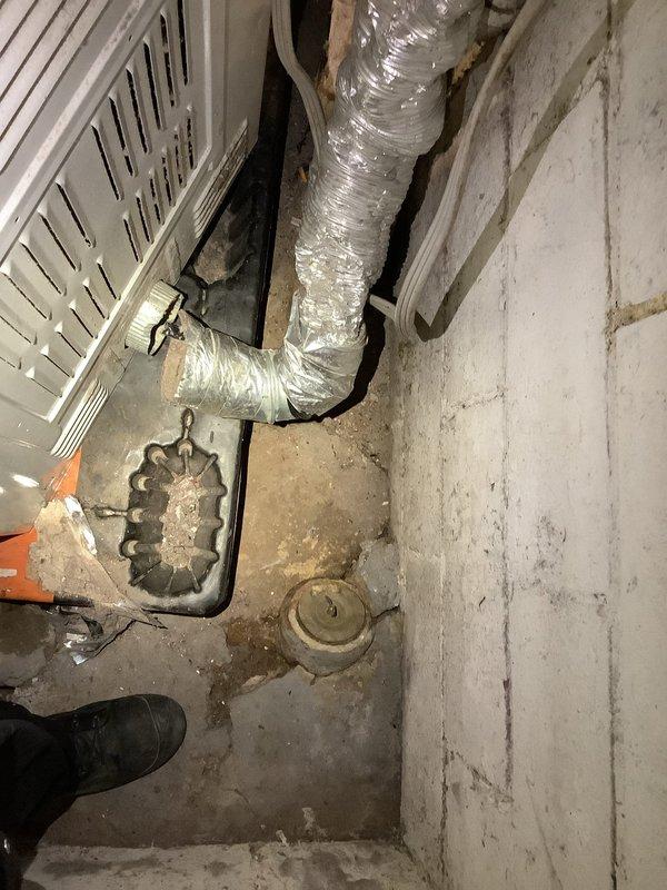 Conducted comprehensive camera inspection of floor drain system in basement utility area. Identified significant debris accumulation around drain grate and documented presence of white powdery material (possible insulation) scattered across concrete floor. Visual inspection also revealed deterioration of drainage components and potential ventilation system issues associated with the nearby HVAC equipment.