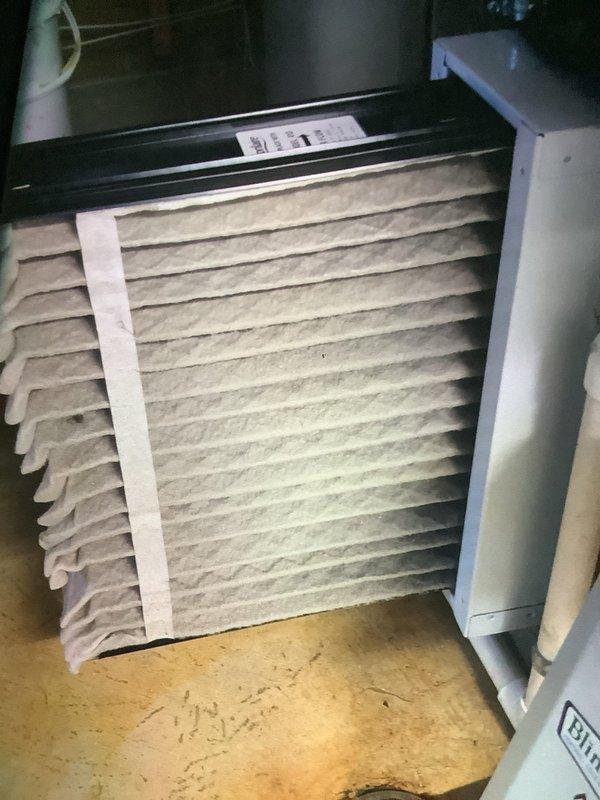 Responded to service call for humidifier maintenance. Inspected Aprilaire humidifier unit mounted on HVAC ductwork and replaced water panel as indicated by system. Also examined air filter which showed significant dust accumulation, indicating replacement was due.