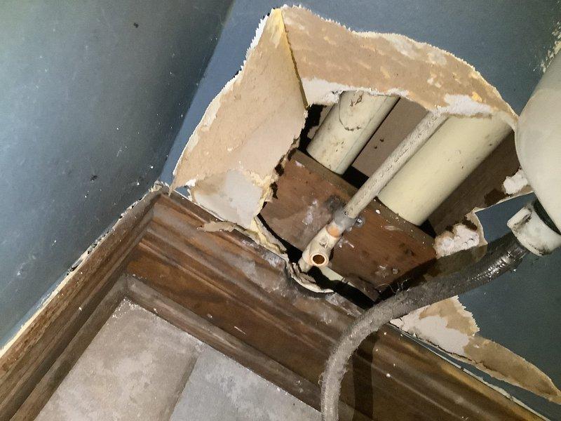 Installed three customer-supplied toilets, repaired water line to toilet with new tee and shutoff, and installed new 2" check valve for sump pump. Found and accessed damaged plumbing through ceiling, replacing compromised connections and addressing water damage in basement area as evidenced by staining around pipe assemblies.