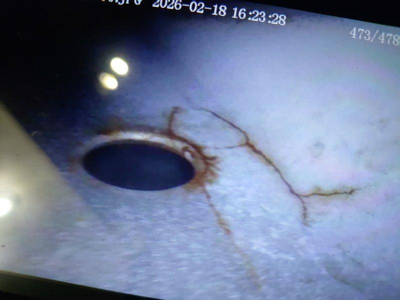 Diagnosed failed heat exchanger on furnace evidenced by significant cracking at combustion chamber and visible rust streaks. Inspection camera revealed extensive fracturing around burner ports, requiring complete system replacement as the unit is unsafe to operate due to potential carbon monoxide hazards.