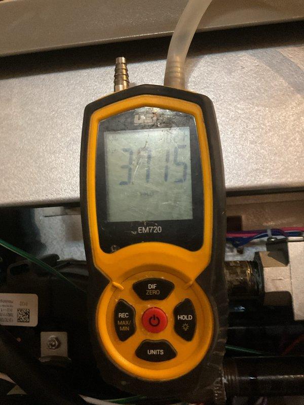 Performed scheduled heating system maintenance on 2-year-old unit. Inspected plumbing components, including copper lines, braided flex hoses, and shut-off valves. Conducted pressure testing with EM720 electronic gauge, obtaining reading of 37.15, confirming system is operating within normal parameters.