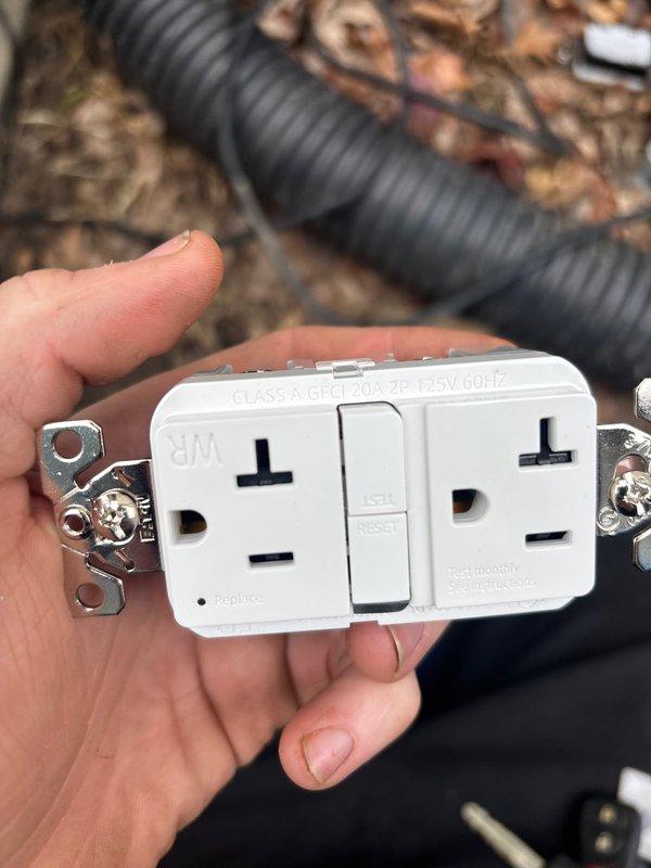 Responded to warranty service call to replace a faulty outlet with a new 20-amp Class A GFCI receptacle. Successfully installed and tested the weatherproof outdoor electrical receptacle, confirming proper operation as indicated by the power indicator light.