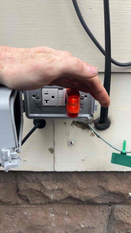 Responded to warranty service call to replace a faulty outlet with a new 20-amp Class A GFCI receptacle. Successfully installed and tested the weatherproof outdoor electrical receptacle, confirming proper operation as indicated by the power indicator light.