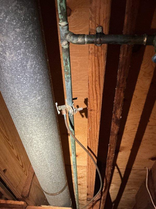 Successfully removed corroded copper ice maker line and outdated saddle valve in basement, replacing them with a proper tee fitting and new shut-off valve. Installed new ice maker supply line to refrigerator, addressing significant pitting and oxidation observed on the original copper piping to prevent further leakage.