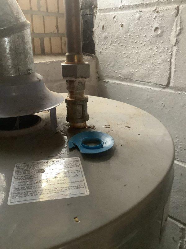 Responded to no hot water call for natural gas water heater with non-functioning pilot light and thermal control. Inspection revealed severe corrosion on gas valve assembly and control components. Determined thermal coupling and gas valve require replacement due to extensive rust damage affecting ignition system.