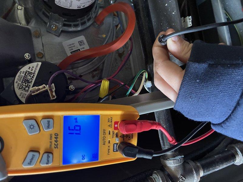 Responded to no-heat call for a newer heating system installed in 2023. Diagnostic testing with Fieldpiece SC440 multimeter revealed low voltage readings (16V and 23.3V) at control board connections. Identified and replaced faulty control board transformer, restoring proper system voltage and heating function.