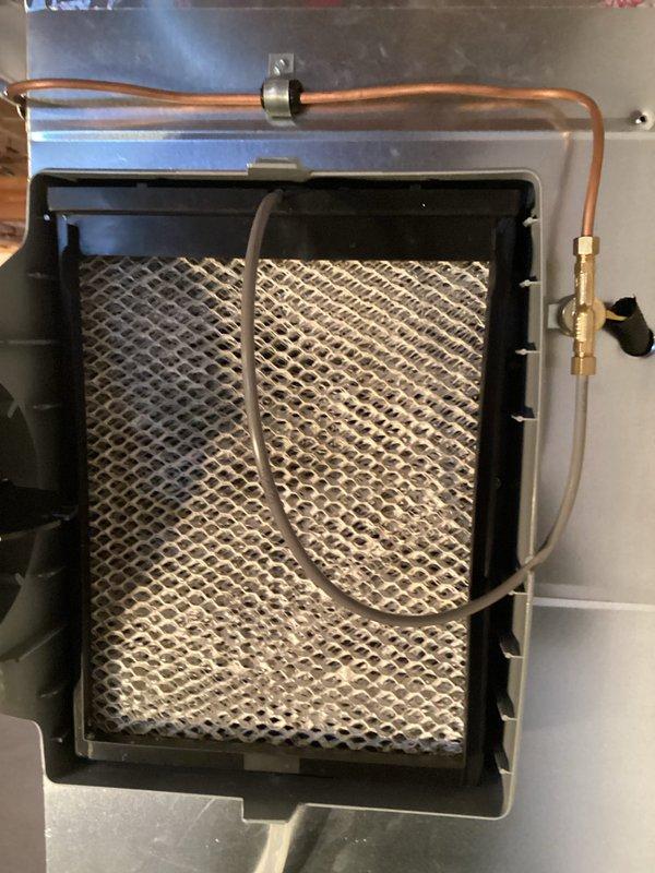 Performed routine maintenance on 3-year-old Lennox furnace system. Inspected evaporator pad in humidifier showing mineral buildup and examined water distribution components. All connections, drainage system with P-trap, and ductwork were verified to be in proper working condition.