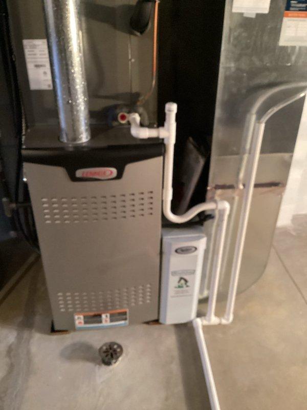 Performed routine maintenance on 3-year-old Lennox furnace system. Inspected evaporator pad in humidifier showing mineral buildup and examined water distribution components. All connections, drainage system with P-trap, and ductwork were verified to be in proper working condition.