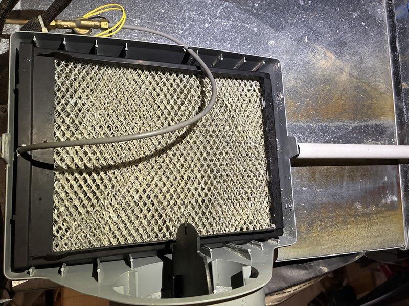 Performed scheduled furnace tune-up, inspecting control board circuitry and connections. Examined humidifier components, noting mineral deposits on housing surface. Verified proper operation of sensors and electronic controls with all connections secure.