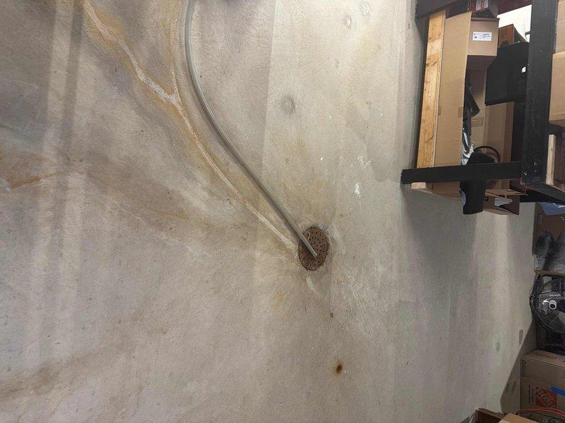 Responded to service call for whole-house drain evaluation. Inspected basement plumbing system including PVC drainage pipes and connections. Cleared clogged master bathroom shower drain and identified water staining around basement floor drain indicating previous backup issues.