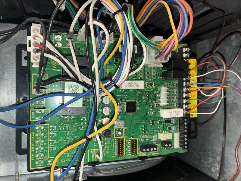 Performed standard MVP heating system maintenance service, inspecting the water supply plumbing components including the copper pipe with blue shut-off valve and insulation. Examined the control circuit board for proper operation, verifying all wire connections (white, yellow, blue, green, pink, and black) were secure and that electronic components showed no signs of damage or failure.