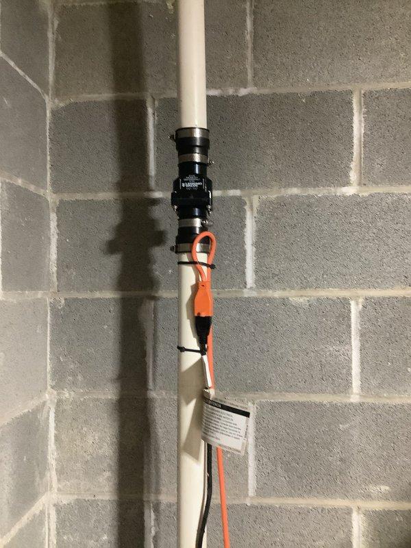 Responded to service call for sump pump water leakage issue. Upon inspection, discovered disconnected downspout causing water to back up into home. Installed new check valve on the PVC discharge pipe, secured with proper metal clamps and verified proper electrical connection to ensure system functionality. Reconnected downspout to complete repair and prevent further water intrusion.