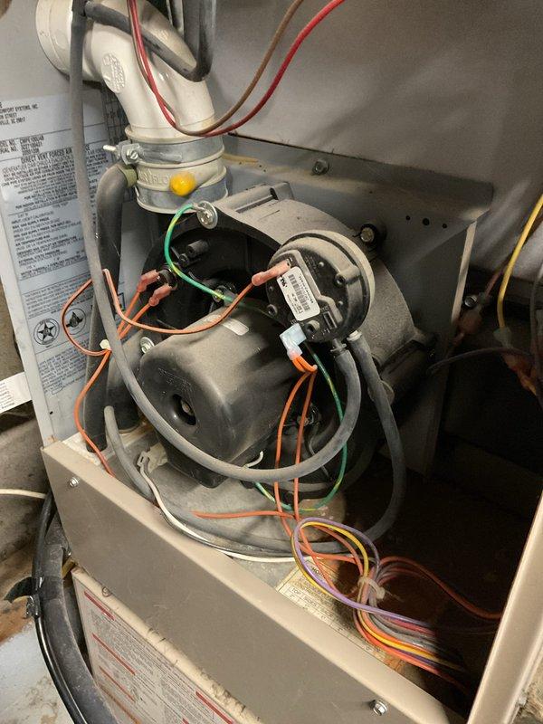 Diagnosed 22-year-old furnace with non-functional draft inducer motor, evidenced by disconnected wiring and improper operation. Replaced draft inducer assembly, reconnected all electrical components, and verified proper system operation through complete heating cycle test.