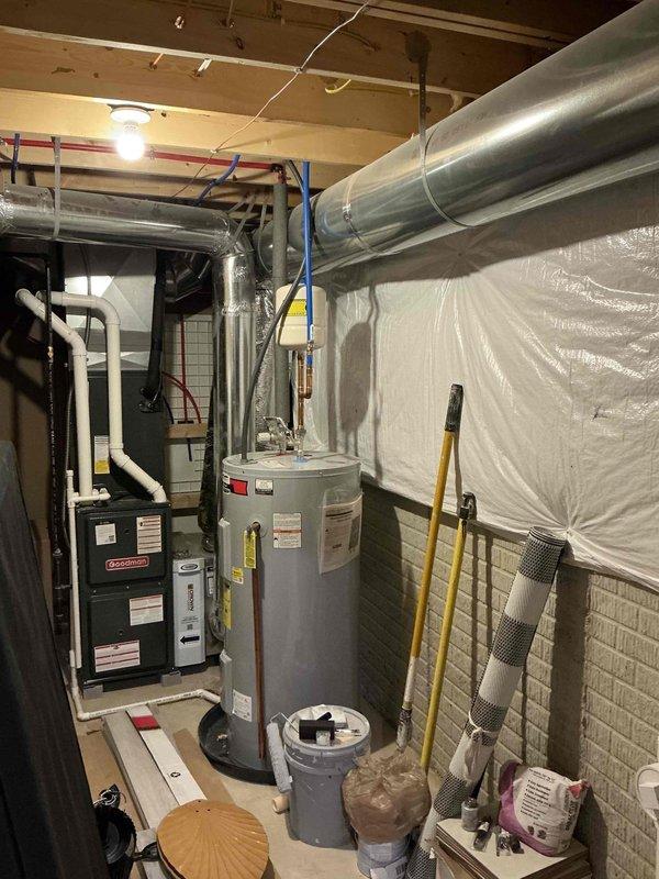 Conducted site assessment for conversion from electric tank water heater to gas tankless system. Evaluated current installation which includes a Goodman HVAC system and existing electric water heater. Inspected PEX water supply lines, gas line accessibility, and venting requirements for proper tankless installation. Reviewed available space and plumbing configuration to determine optimal mounting location and necessary modifications.