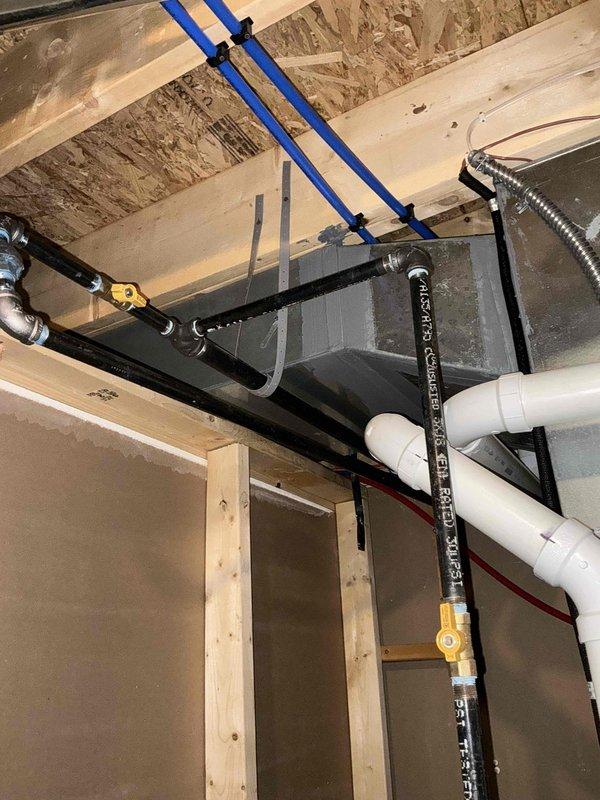 Conducted site assessment for conversion from electric tank water heater to gas tankless system. Evaluated current installation which includes a Goodman HVAC system and existing electric water heater. Inspected PEX water supply lines, gas line accessibility, and venting requirements for proper tankless installation. Reviewed available space and plumbing configuration to determine optimal mounting location and necessary modifications.