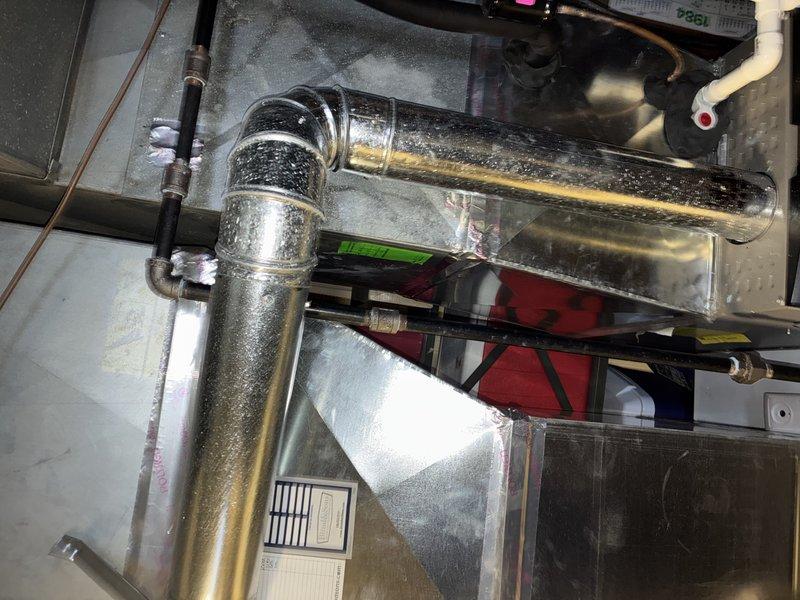 Completed scheduled maintenance service on a 4-year-old Lennox heating system. Inspected all components including furnace, humidifier, ductwork, and PVC condensate drainage system; all systems functioning properly with no issues detected. Documented system condition with photos showing main furnace unit, connected components, and metallic ductwork for service records.