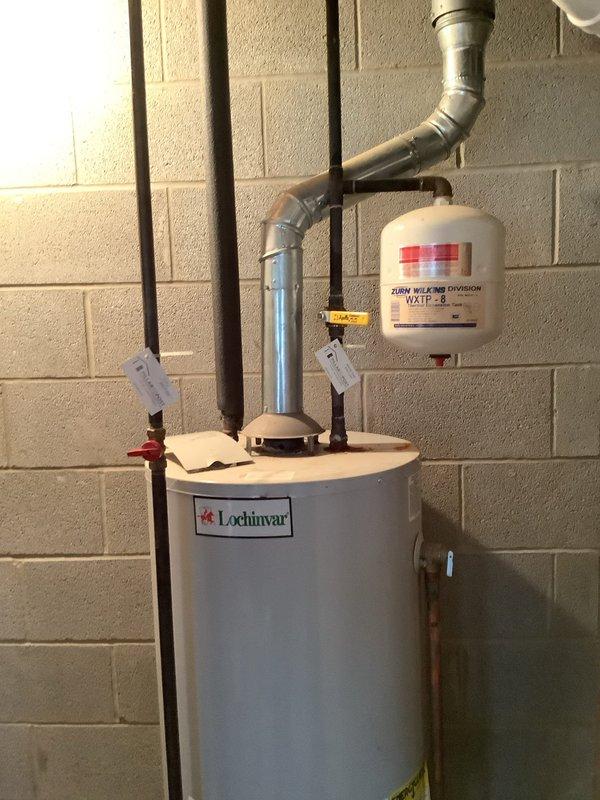 Performed diagnostic assessment on 50-gallon gas water heater to determine viability of repair versus replacement. Inspection revealed a Lochinvar unit with proper venting system, expansion tank, and pressure relief valve installed. Customer was provided with replacement options based on current condition of equipment.