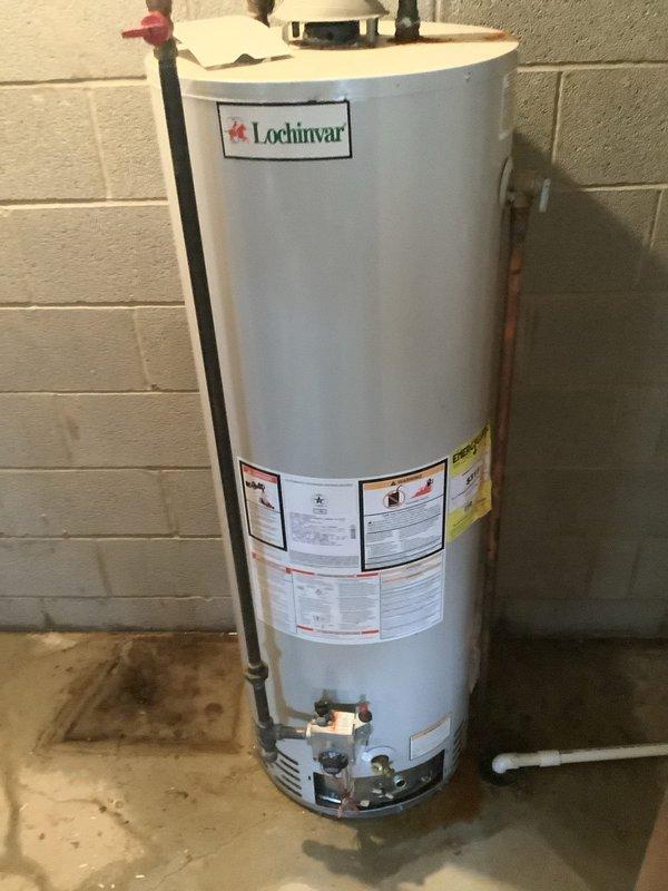 Performed diagnostic assessment on 50-gallon gas water heater to determine viability of repair versus replacement. Inspection revealed a Lochinvar unit with proper venting system, expansion tank, and pressure relief valve installed. Customer was provided with replacement options based on current condition of equipment.