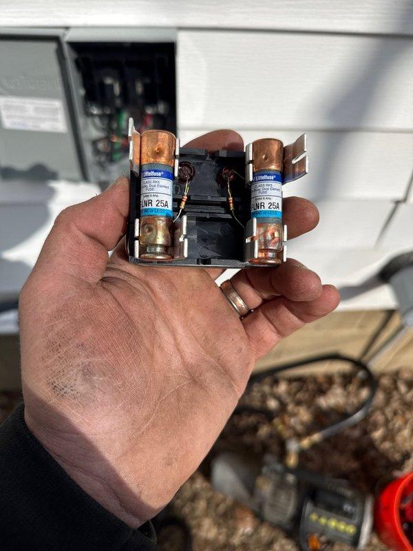 Completed installation of a multi-zone Daikin mini-split system (model FTXV12AVJU9/Y175190). Installed 25A NR fuses in the disconnect box and verified proper electrical connections to the outdoor unit. Documented installation with photos of electrical components and indoor unit identification for warranty registration.