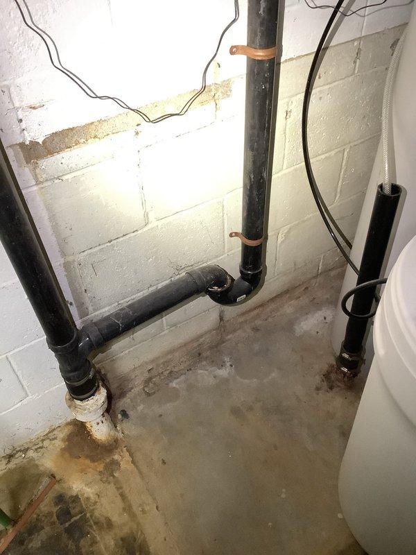 Successfully cleared kitchen sink clog that was affecting drainage to washer connection pipe. Inspected PVC and copper plumbing infrastructure in basement utility area, identifying mineral deposits at pipe junctions as contributing factor to the blockage.