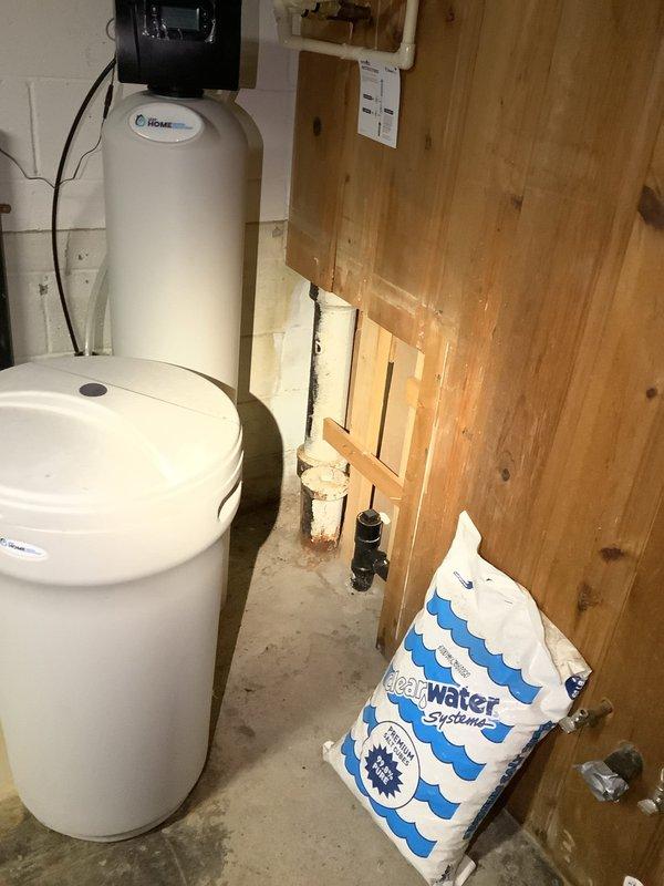 Successfully cleared kitchen sink clog that was affecting drainage to washer connection pipe. Inspected PVC and copper plumbing infrastructure in basement utility area, identifying mineral deposits at pipe junctions as contributing factor to the blockage.