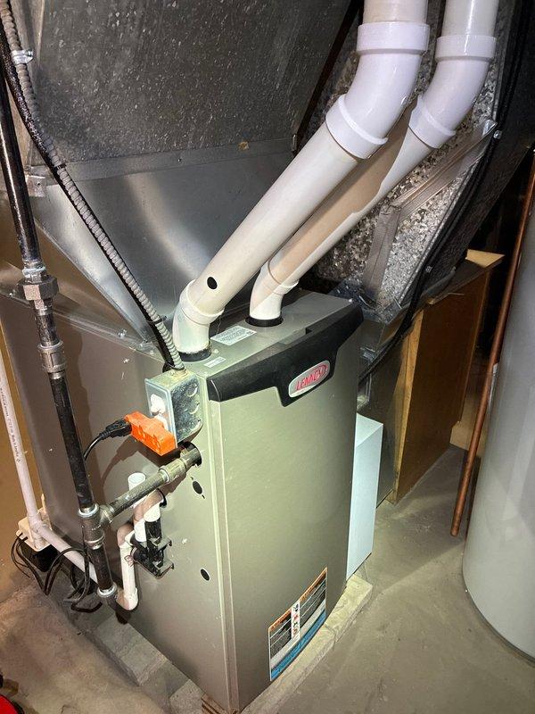 Performed scheduled MVP maintenance on Lennox furnace system. Inspected control board components including capacitors, integrated circuits, and terminal connections, with system displaying normal operation (control board showing "7" on LED display). Visual inspection confirmed proper installation of PVC venting, condensate drainage, and ductwork connections with all components in good working condition.