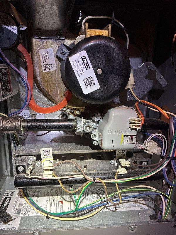 Completed routine heating maintenance on customer's HVAC system. Inspected Honeywell control valve and pressure switch components, finding all electrical connections secure and operational. Identified significant corrosion and mineral buildup in condensate drain pipe requiring cleaning to prevent potential blockage and system efficiency issues.