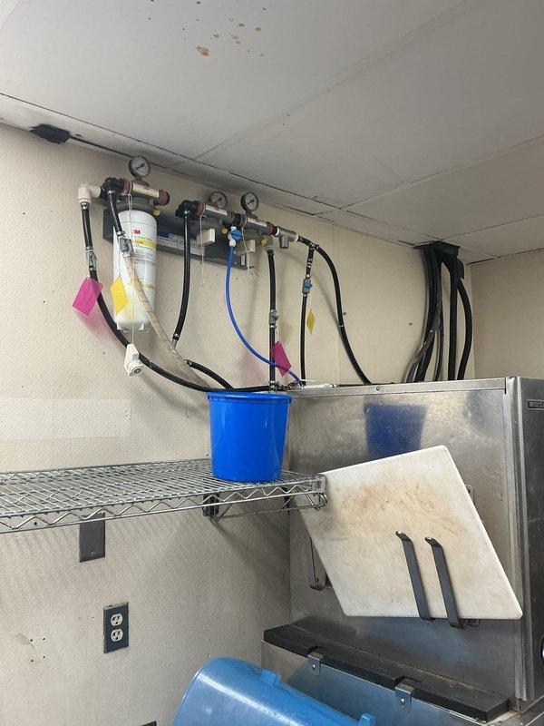 Completed thorough inspection of commercial filtration system including pressure gauges, valves, and associated PVC piping. Examined water line connections and valve functionality within metal enclosure. Documented current system condition with photos for reference.