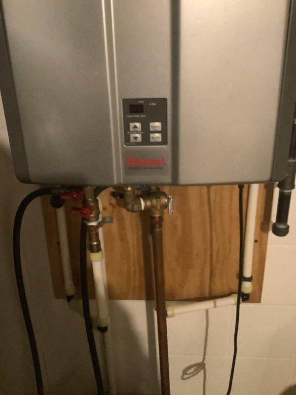 Successfully completed descaling service on Rinnai tankless water heater, removing mineral deposits using appropriate flush method. Inspected all plumbing connections including copper supply lines, PVC drainage, and verified proper operation of shut-off valves. System was tested after service and confirmed to be functioning optimally with control panel displaying normal operation.
