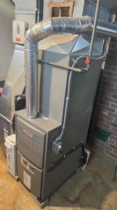 Completed seasonal tune-up service on two Lennox furnace systems located in basement utility area. Both units were inspected and serviced according to manufacturer specifications, including examination of ductwork connections, condensate drain lines, and ventilation systems. Confirmed proper operation of both heating systems with normal airflow and no safety concerns identified.